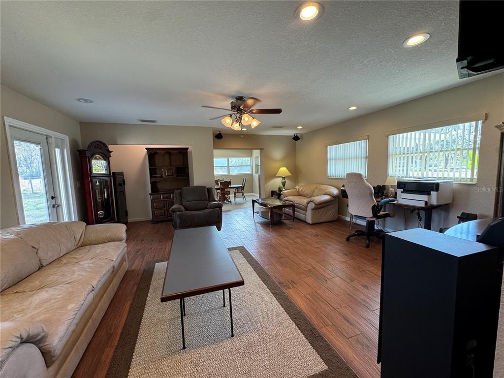 5333 Deeson Road Lakeland, FL 33810 - Photo 16 of 44 a living room with furniture a large window and a chandelier