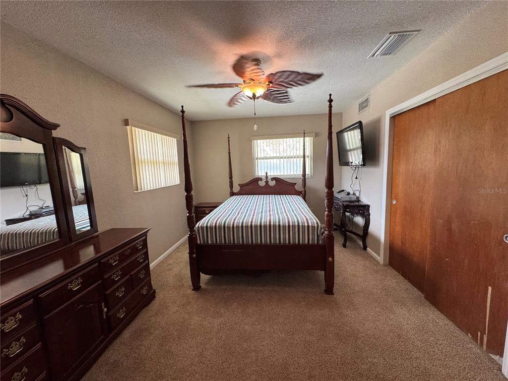 5333 Deeson Road Lakeland, FL 33810 - Photo 22 of 44 a bedroom with a bed and a flat tv screen on the dresser