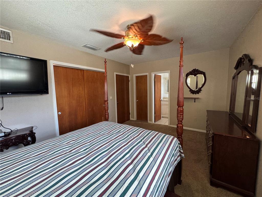 5333 Deeson Road Lakeland, FL 33810 - Photo 23 of 44 a bedroom with a bed and a flat screen tv