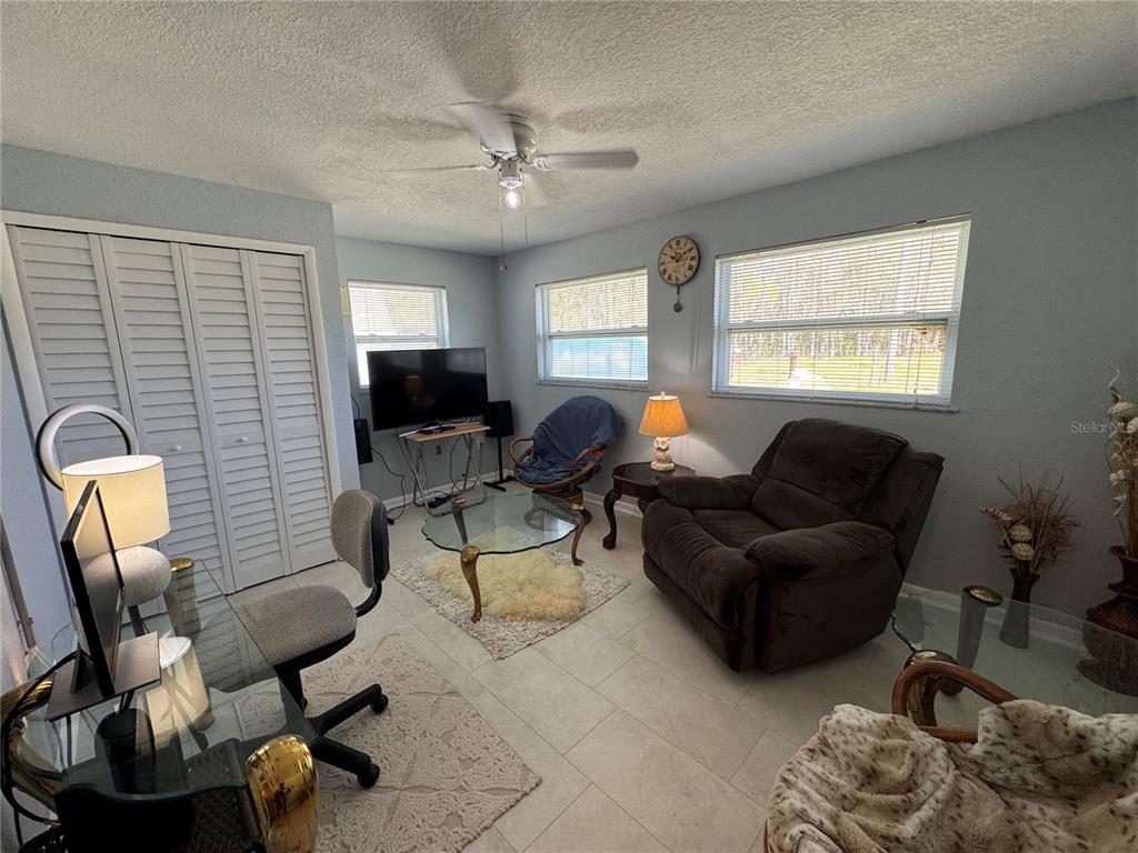 5333 Deeson Road Lakeland, FL 33810 - Photo 24 of 44 a living room with furniture a flat screen tv and a window