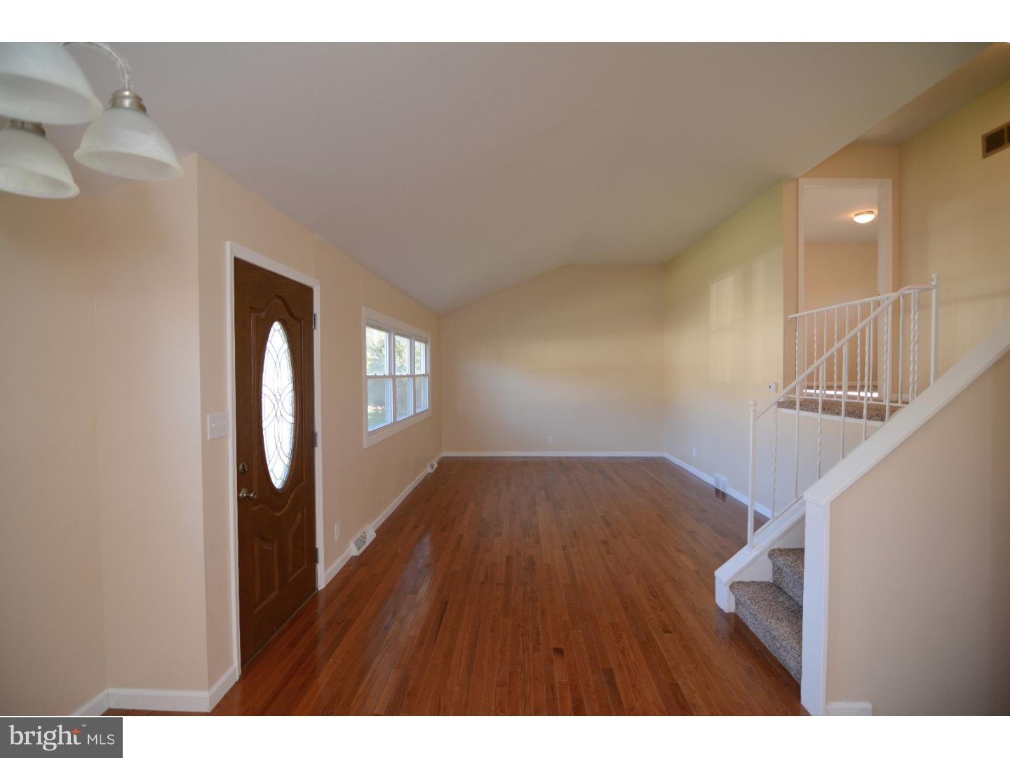25 Merion Road Newark, DE 19713 - Photo 4 of 23 a view of an empty room with wooden floor and a window