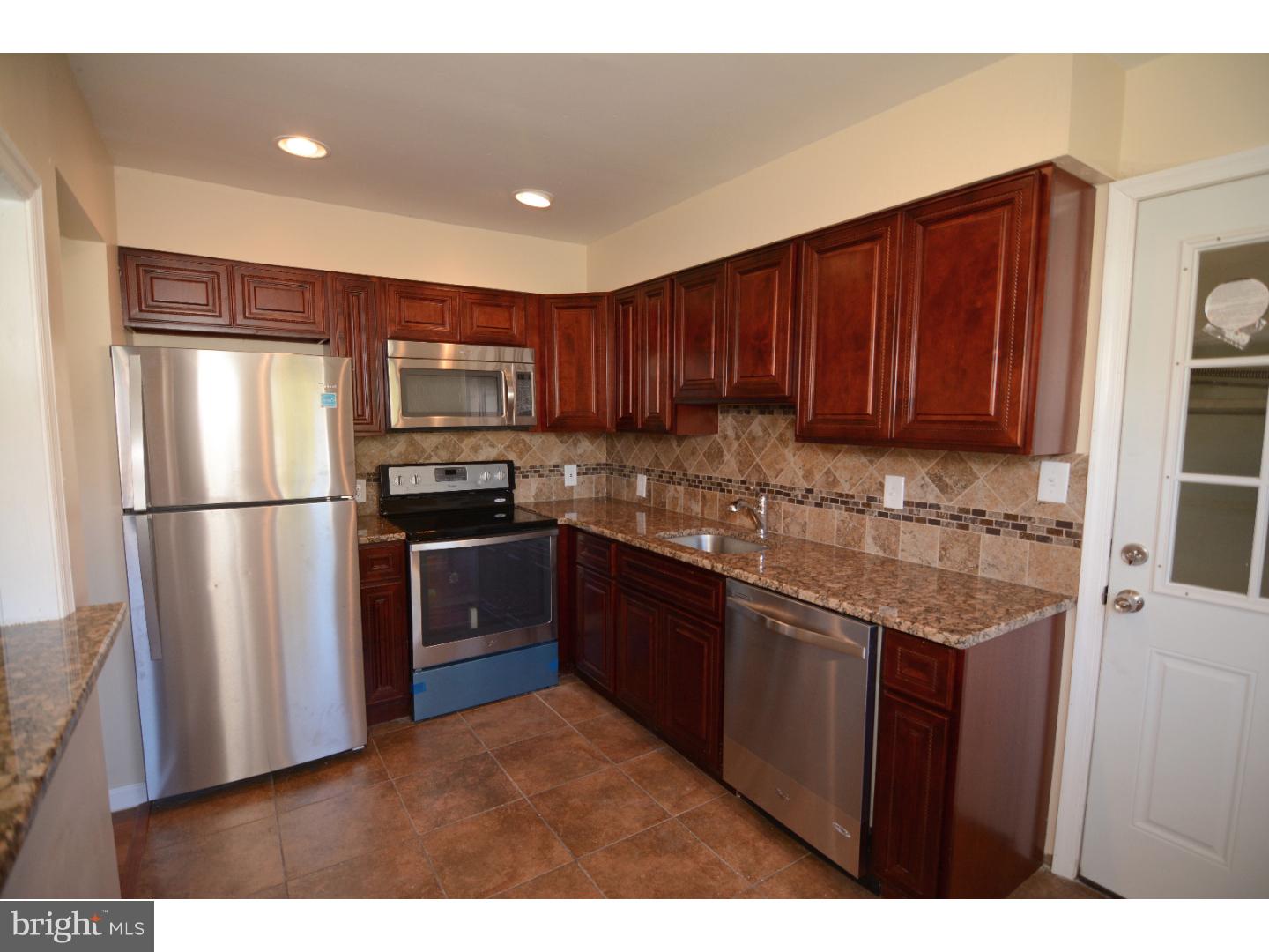 25 Merion Road Newark, DE 19713 - Photo 8 of 23 a kitchen with granite countertop stainless steel appliances and wooden cabinets
