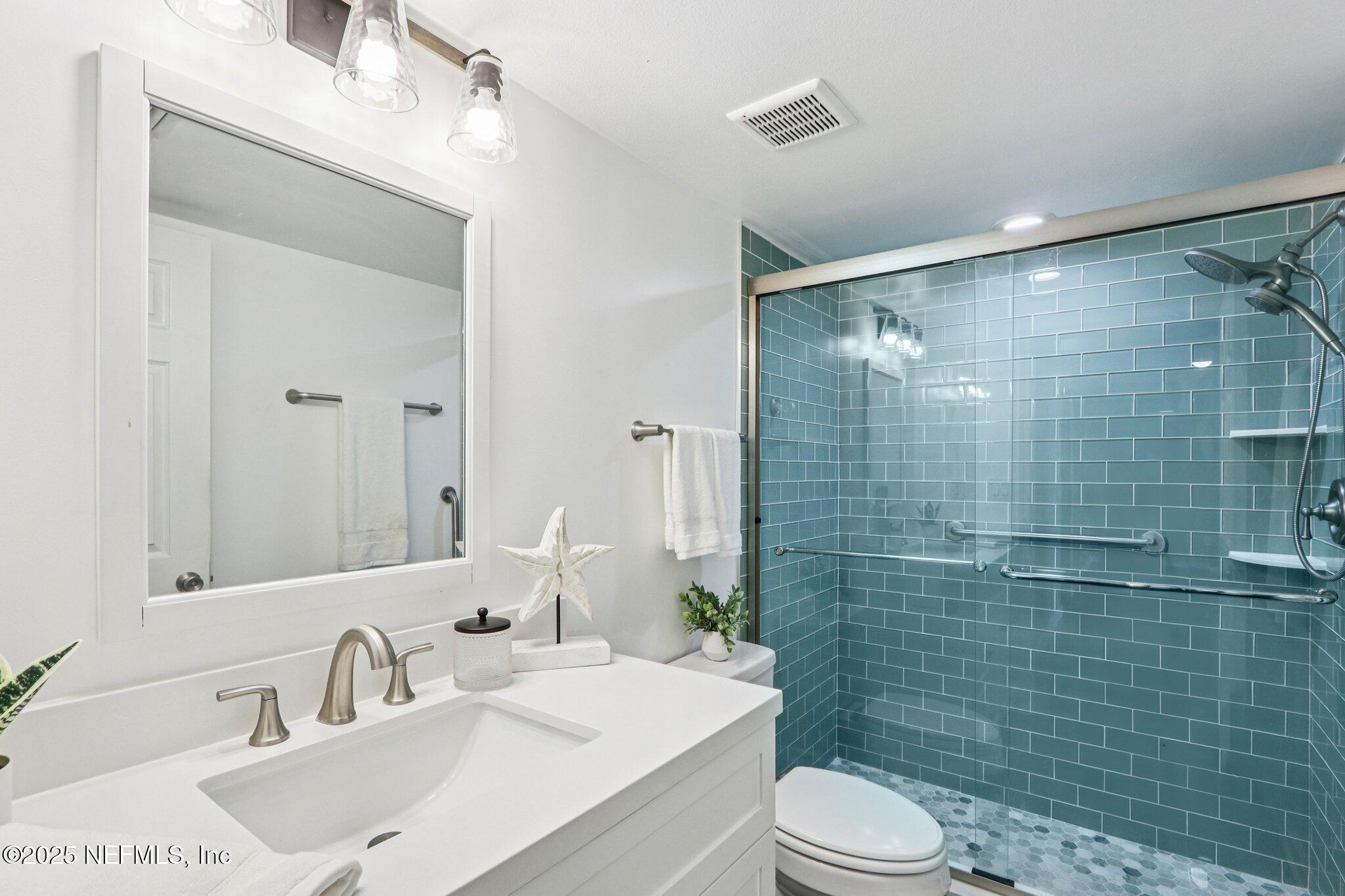 200 16th Street, Unit 103A St. Augustine Beach, FL 32080 - Photo 26 of 51 a bathroom with a sink toilet and shower