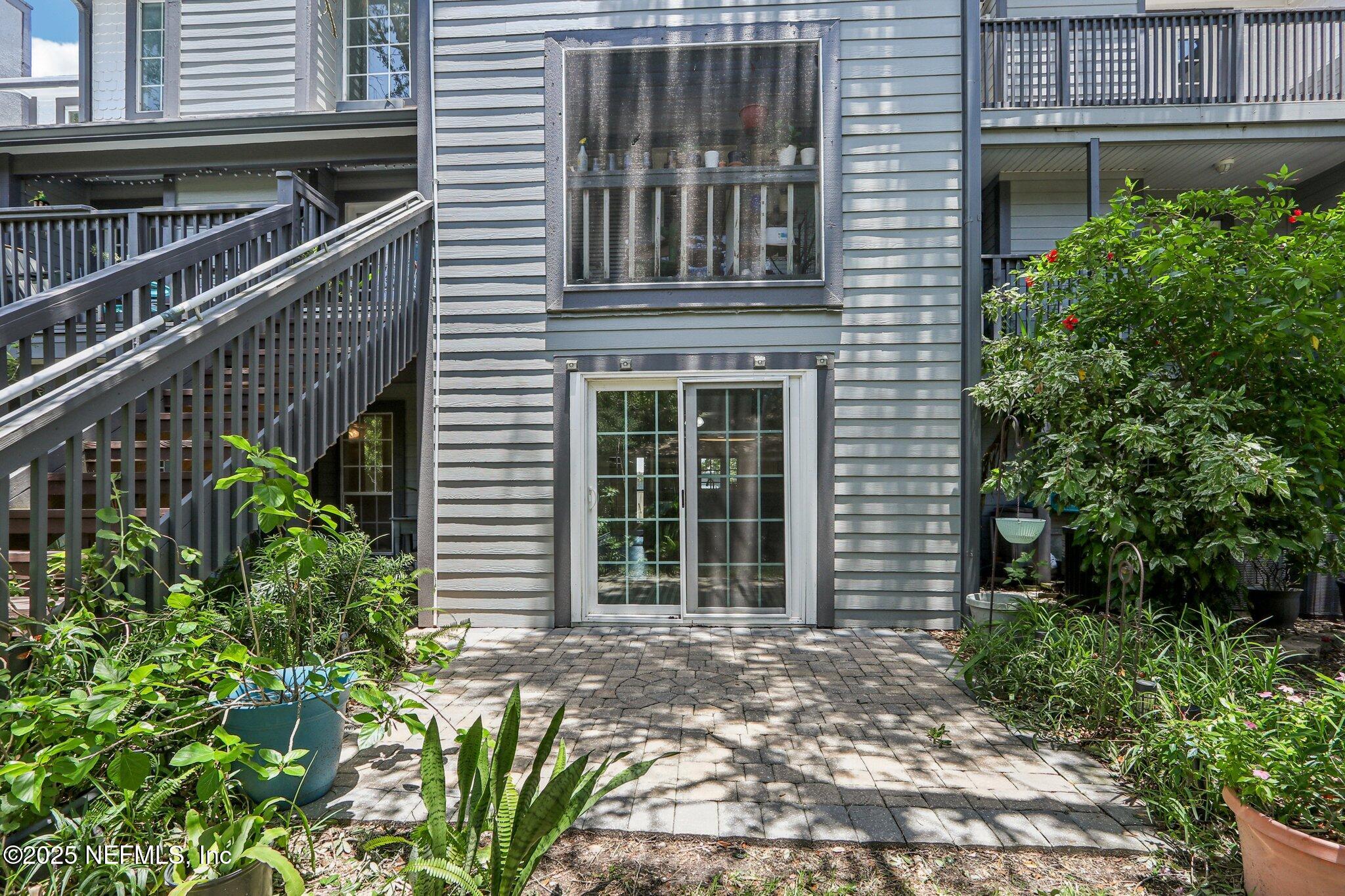 200 16th Street, Unit 103A St. Augustine Beach, FL 32080 - Photo 34 of 51 a front view of a house with garden