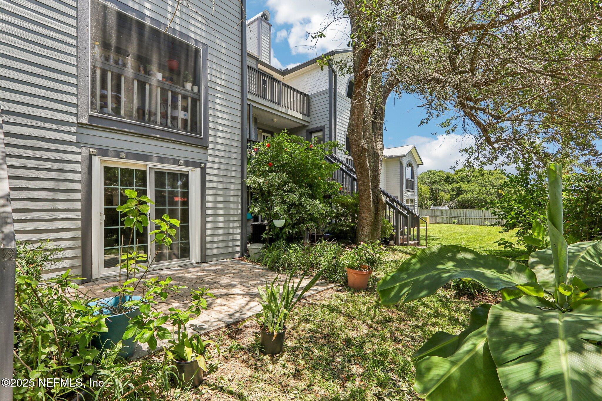 200 16th Street, Unit 103A St. Augustine Beach, FL 32080 - Photo 36 of 51 front view of a house with a yard