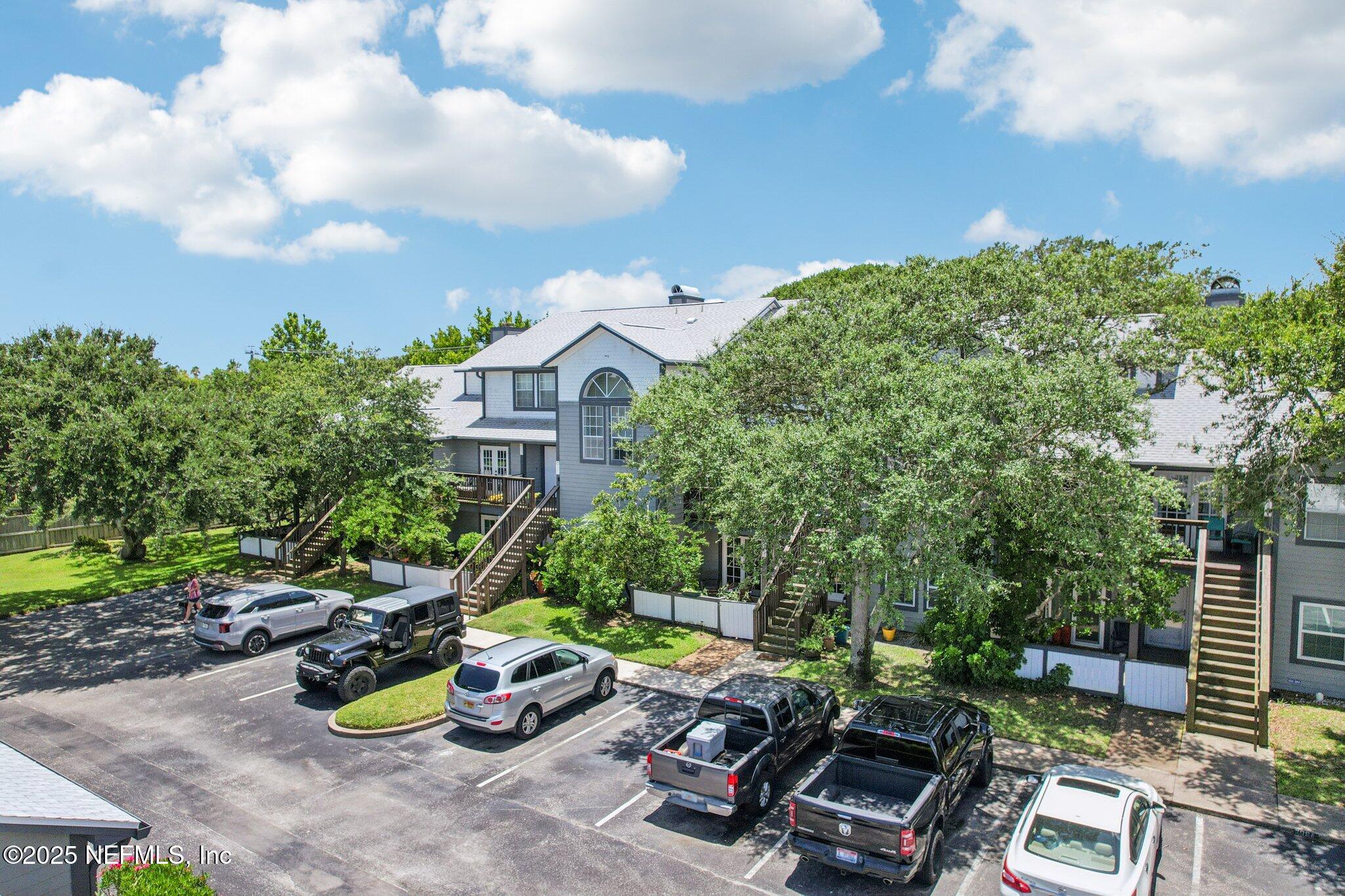 200 16th Street, Unit 103A St. Augustine Beach, FL 32080 - Photo 39 of 51 a view of a chairs and table in backyard