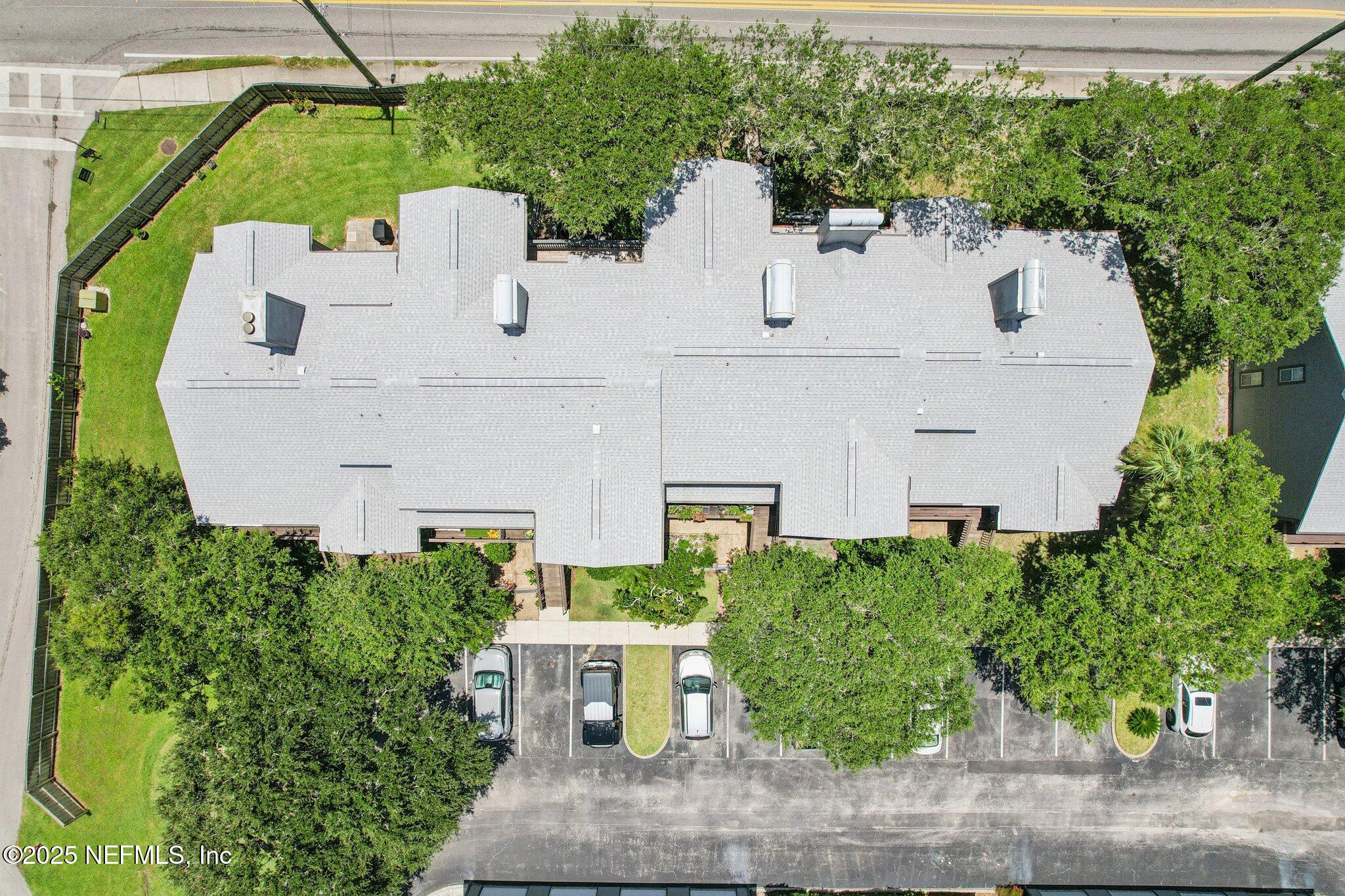200 16th Street, Unit 103A St. Augustine Beach, FL 32080 - Photo 40 of 51 an aerial view of a house with a yard and table and chairs