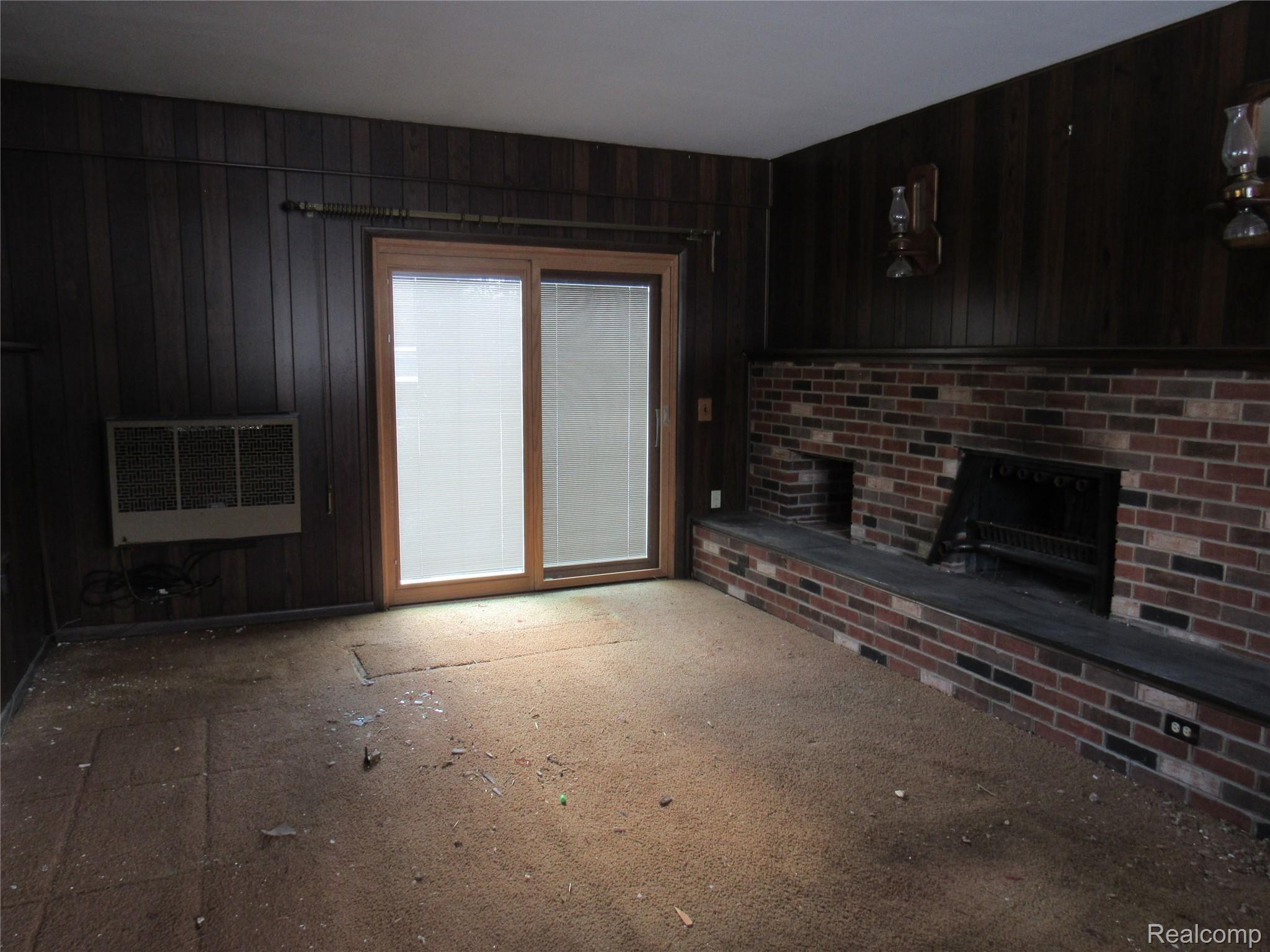 5740 Textile Road Ypsilanti, MI 48197 - Photo 13 of 62 Spacious Family room features a Natural wood burning Fireplace and a PELLA sliding door leading to the wooded rear yard!