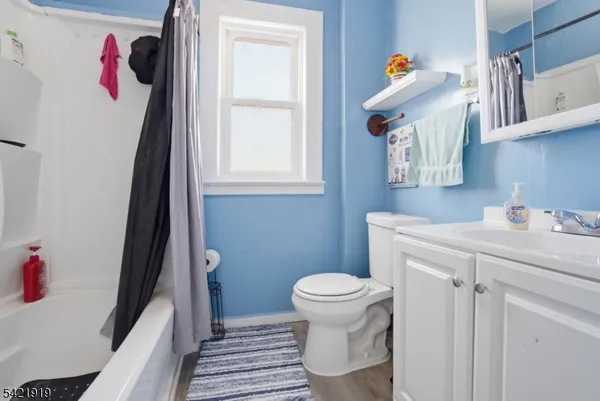 a bathroom with a sink toilet and window