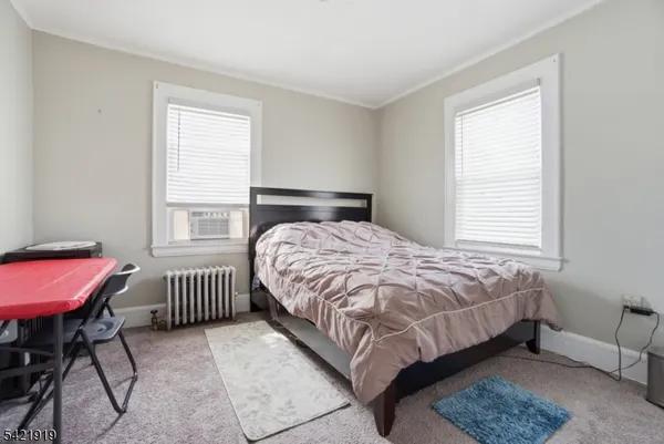 a bedroom with a bed chair and a window