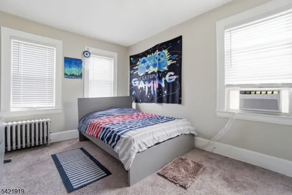 a bedroom with a bed and a window with outer view