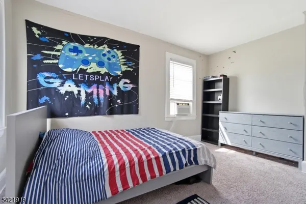 a bedroom with a bed and a painting on the wall