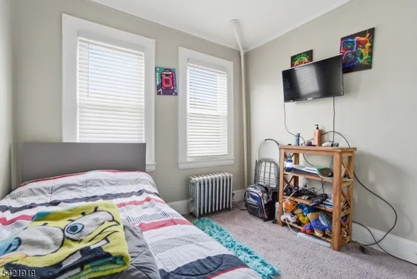 a bedroom with a bed and a tv in it