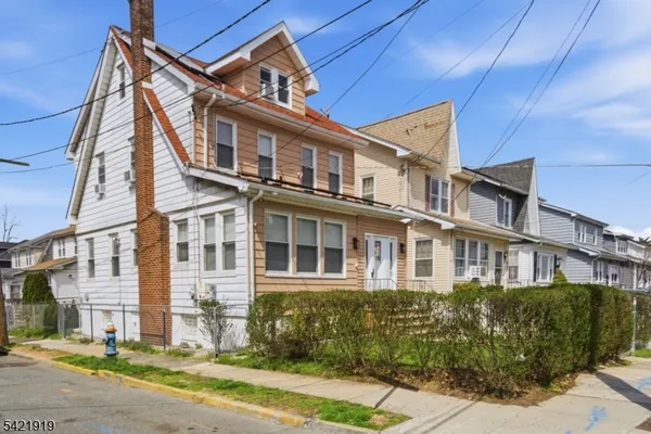 a front view of a residential apartment building with a yard