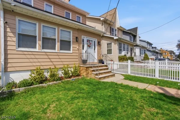 a front view of a house with a yard table and chairs
