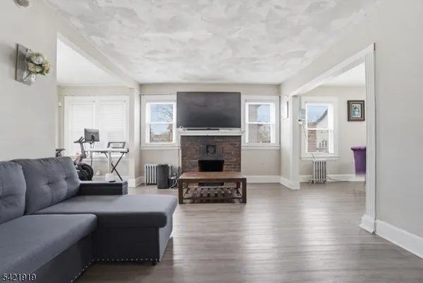 a living room with furniture flat screen tv and a fireplace