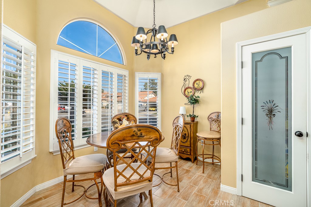 1877 Cashew Tree Street Hemet, CA 92545 - Photo 12 of 32 a dining room with chandelier fan and wooden floor