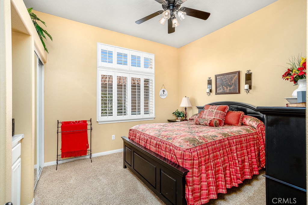 1877 Cashew Tree Street Hemet, CA 92545 - Photo 20 of 32 a bedroom with a bed and a chandelier