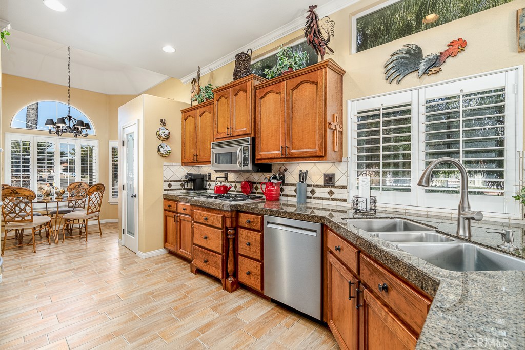 1877 Cashew Tree Street Hemet, CA 92545 - Photo 10 of 32 a kitchen with stainless steel appliances a sink stove and cabinets