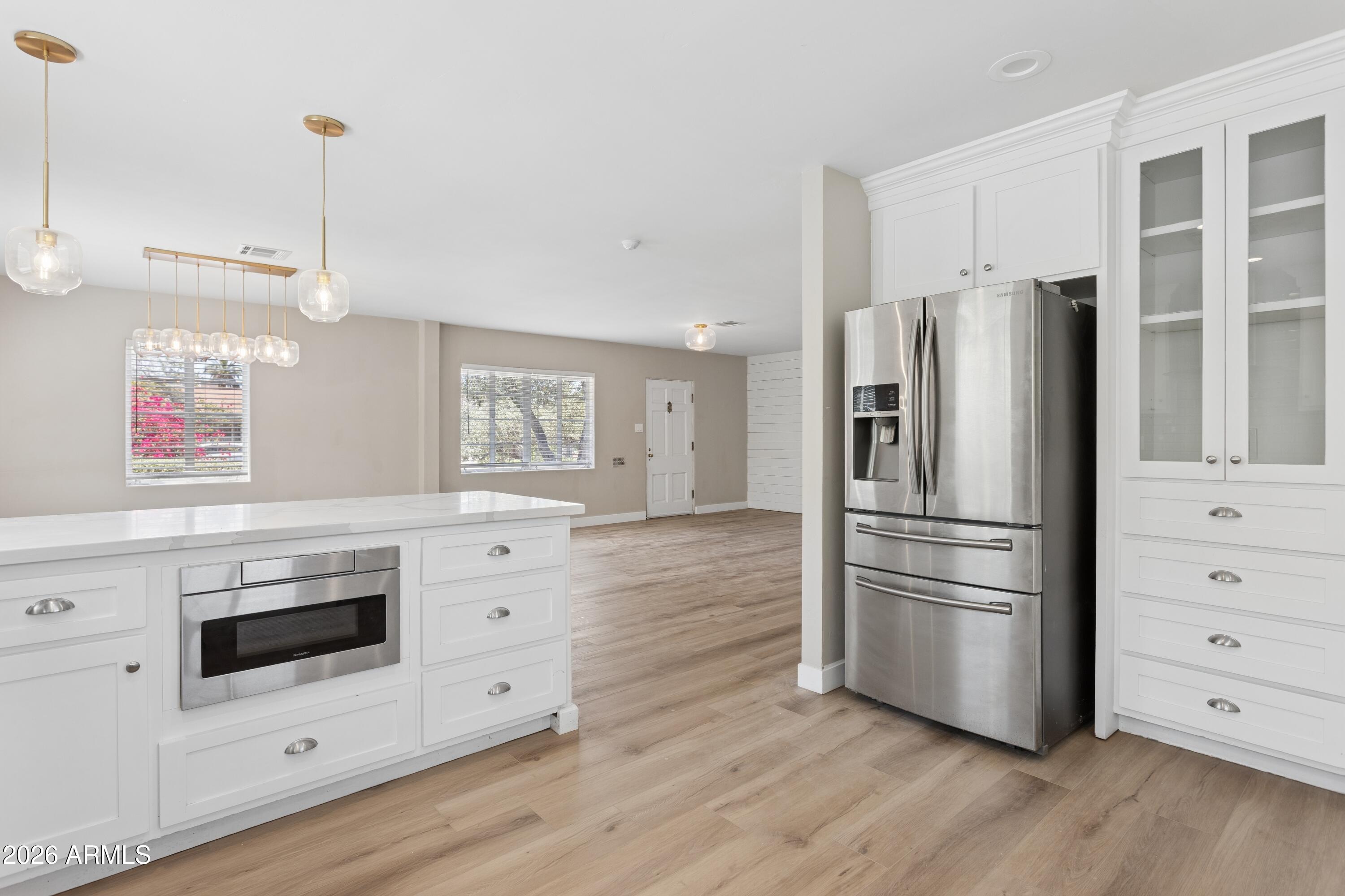 322 West Coronado Road Phoenix, AZ 85003 - Photo 14 of 93 a kitchen with stainless steel appliances white cabinets and wooden floor
