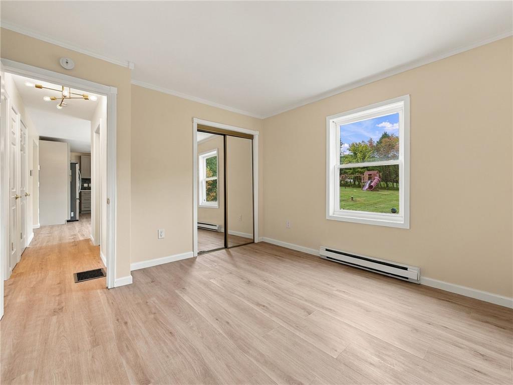 90 Gun Club Road Palmerton, PA 18071 - Photo 39 of 58 Smooth wood flooring and a mirrored closet define this bedroom overlooking the green backyard.