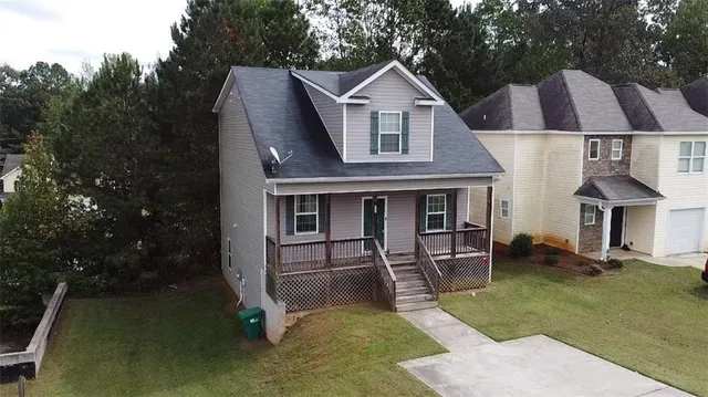 a aerial view of a house with table and chairs
