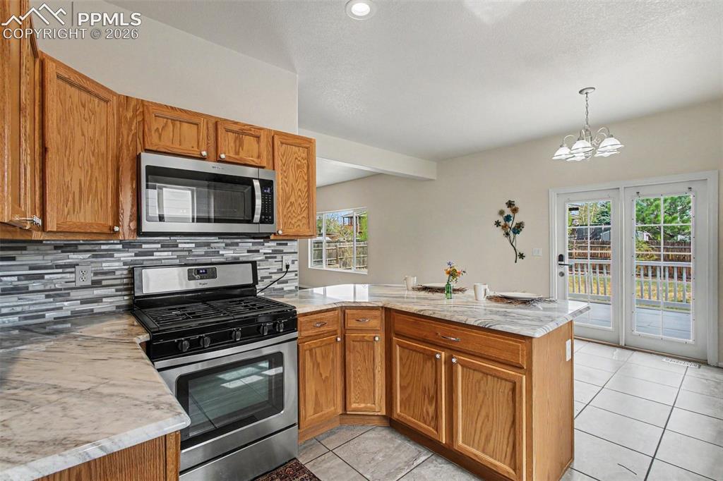 12210 Crystal Downs Road Peyton, CO 80831 - Photo 8 of 40 a kitchen with a sink stove and microwave