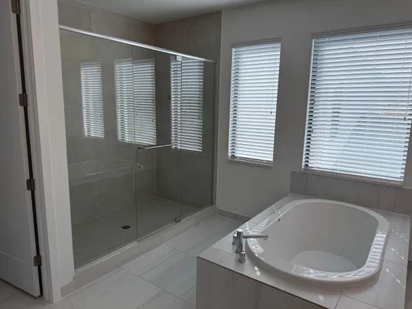 a bathroom with a tub and shower