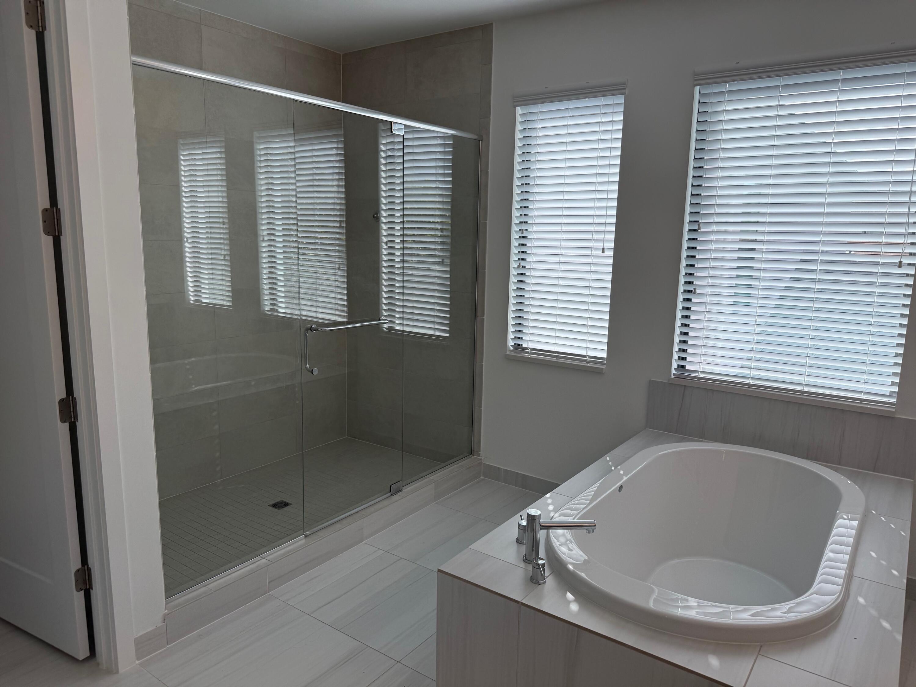 8055 White Wave Terrace Boca Raton, FL 33496 - Photo 11 of 20 a bathroom with a tub and shower