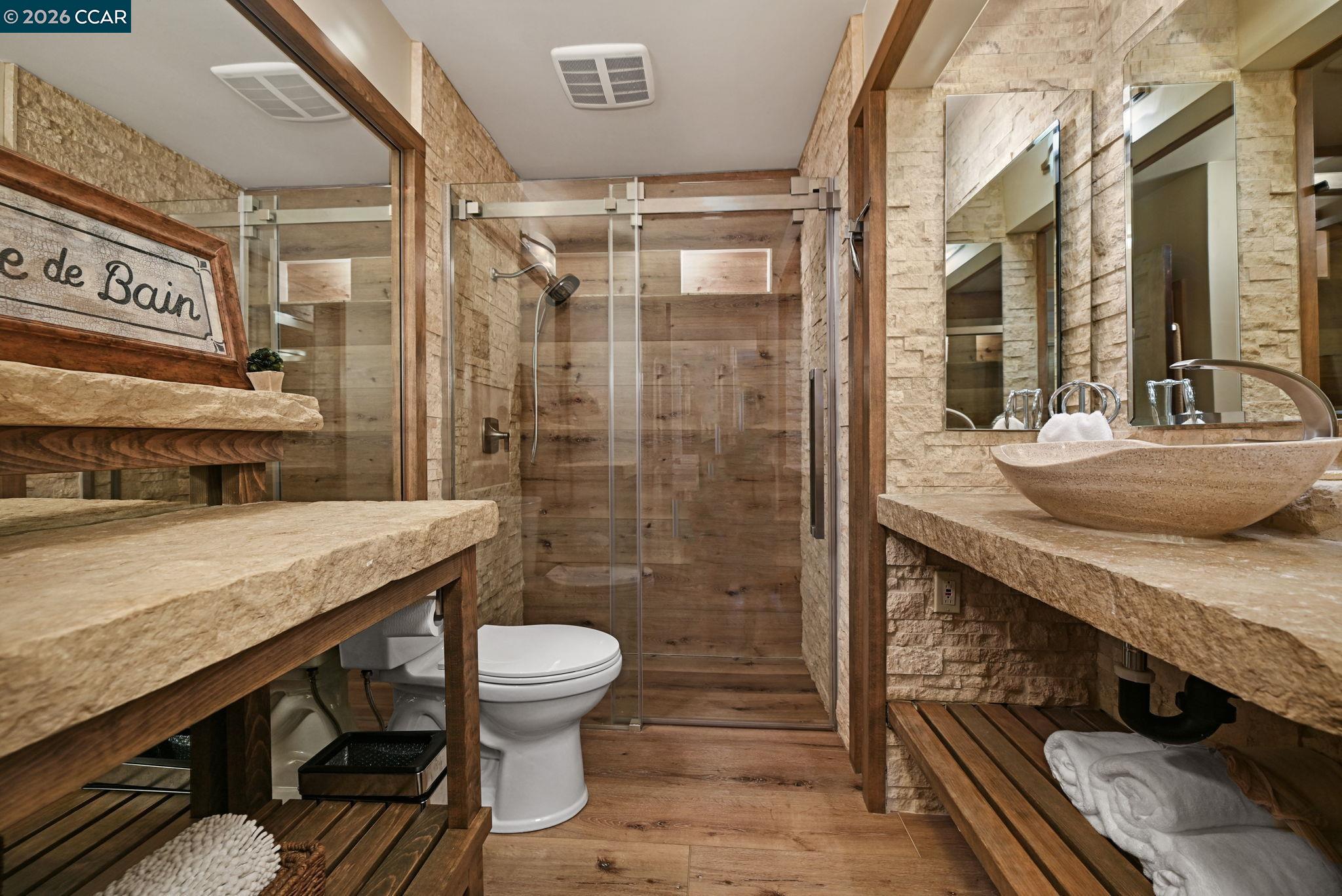 490 St Marys Road Lafayette, CA 94549 - Photo 28 of 61 a bathroom with a granite countertop sink a toilet a mirror and shower