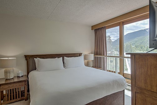 22340 Highway 6, Unit 1785 Keystone, CO 80435 - Photo 12 of 28 a bedroom with a large bed and a large window