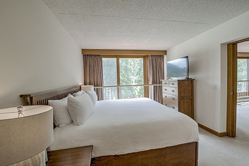 22340 Highway 6, Unit 1785 Keystone, CO 80435 - Photo 13 of 28 a bedroom with a bed and a large window