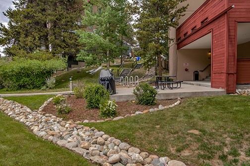 22340 Highway 6, Unit 1785 Keystone, CO 80435 - Photo 24 of 28 a front view of a house with a garden and a tree