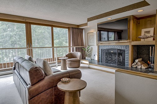 22340 Highway 6, Unit 1785 Keystone, CO 80435 - Photo 3 of 28 a living room with furniture a fireplace and a large window