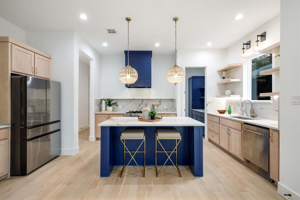 a kitchen with a sink appliances and cabinets