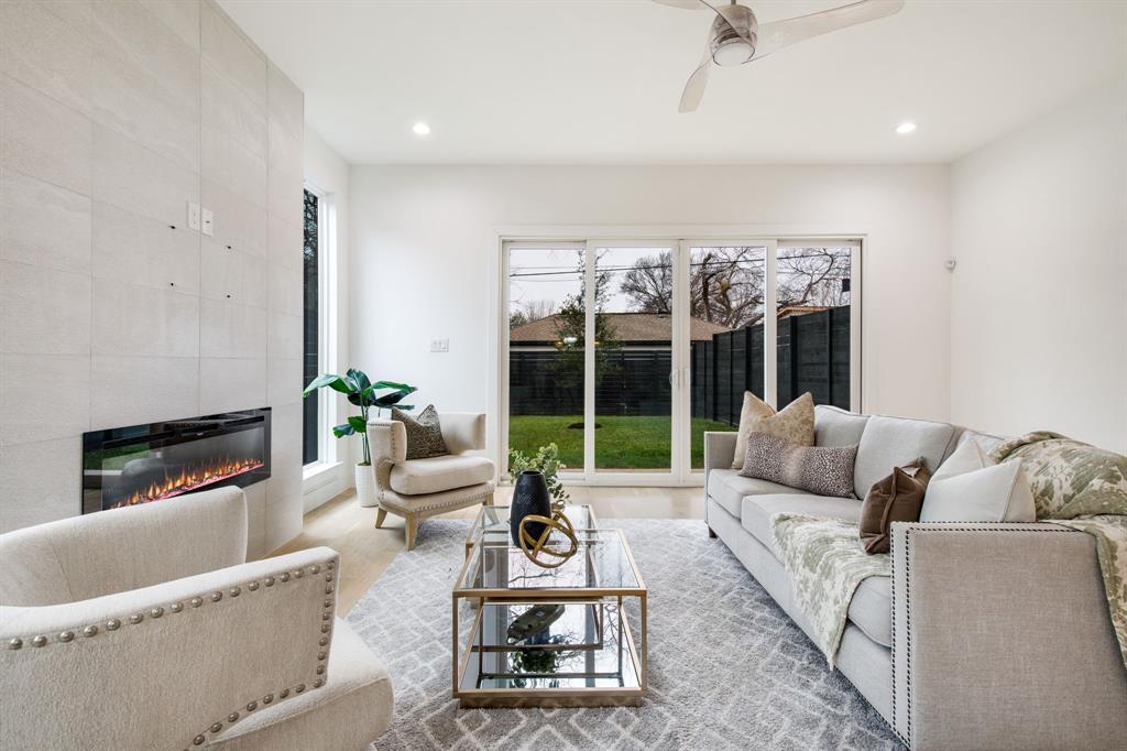 807 South Glasgow Drive Dallas, TX 75223 - Photo 14 of 39 a living room with furniture large windows and a fireplace
