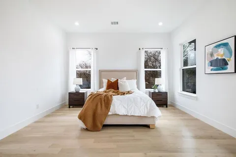 a bedroom with a bed and glass window