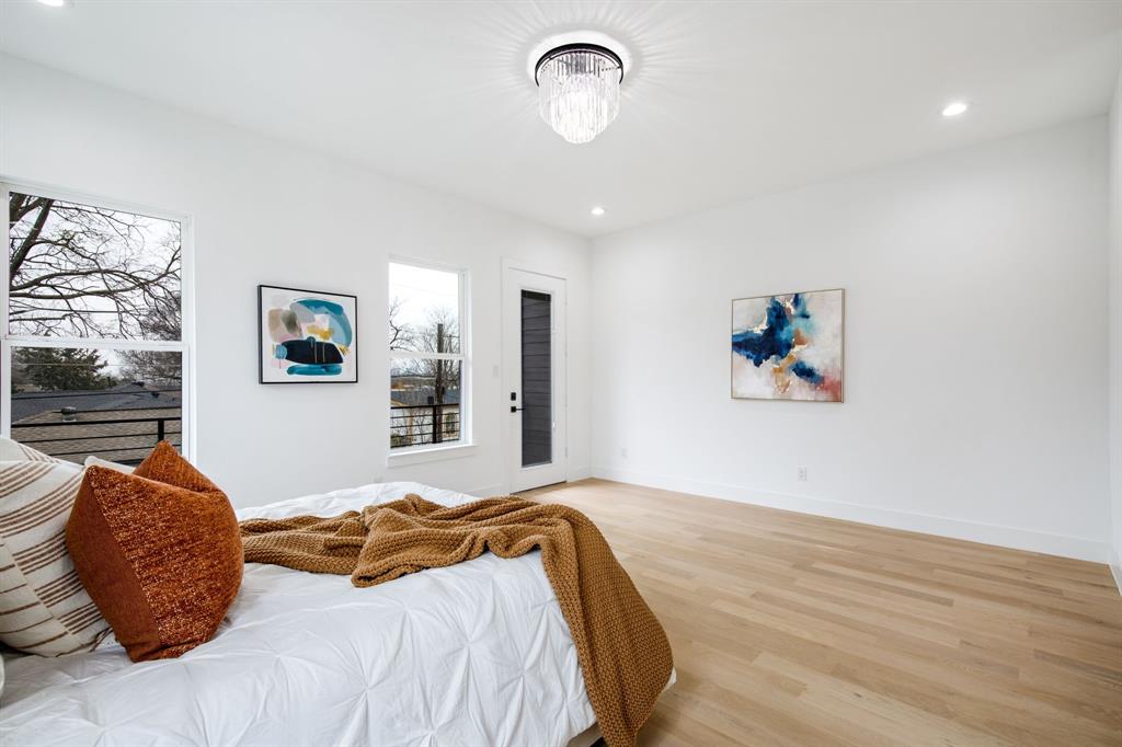 807 South Glasgow Drive Dallas, TX 75223 - Photo 29 of 39 a bedroom with a bed and a painting on the wall