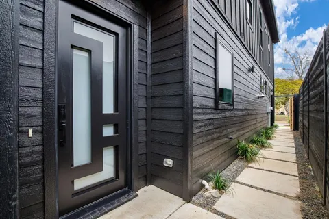 a view of a house with a door and wooden floor