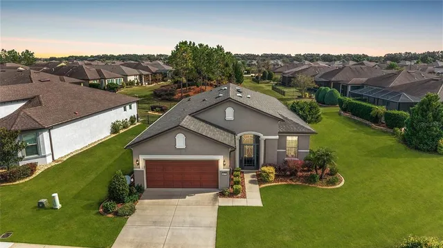 an aerial view of residential houses with outdoor space and river