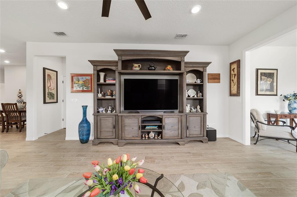 6479 Southwest 94th Circle Ocala, FL 34481 - Photo 12 of 82 a living room with furniture and a flat screen tv