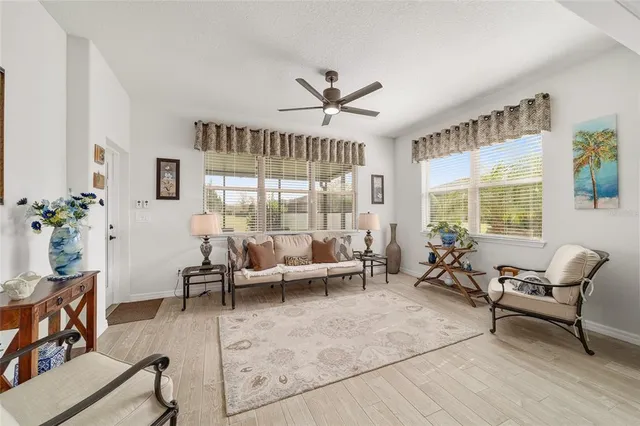 a kitchen with stainless steel appliances kitchen island granite countertop a table chairs and wooden floor