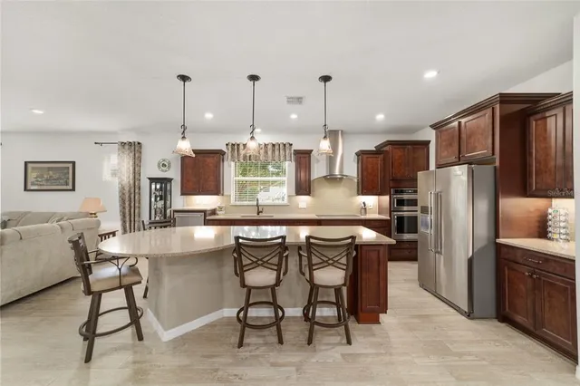 a view of a livingroom with wooden floor and a bathroom