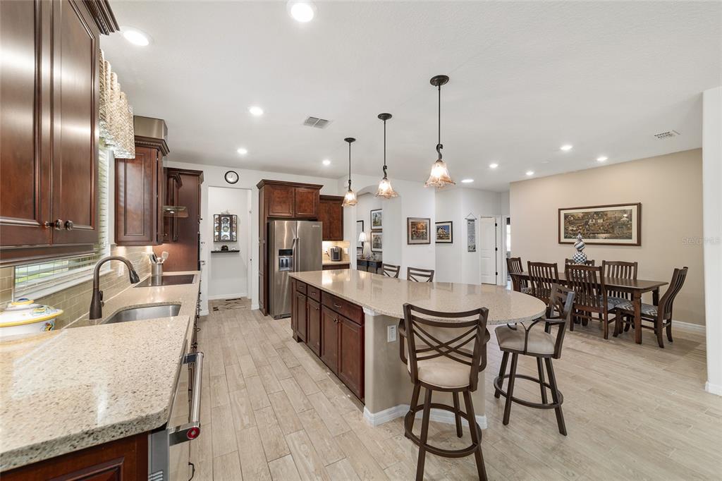 6479 Southwest 94th Circle Ocala, FL 34481 - Photo 26 of 82 a kitchen with stainless steel appliances kitchen island granite countertop a sink and cabinets