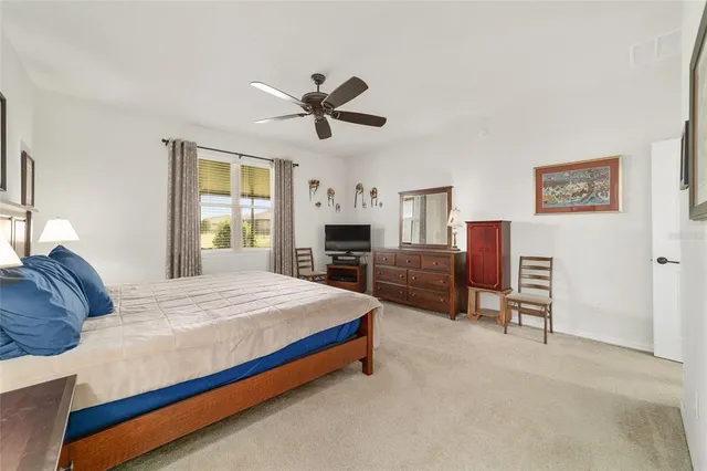 a dining room with furniture and large windows