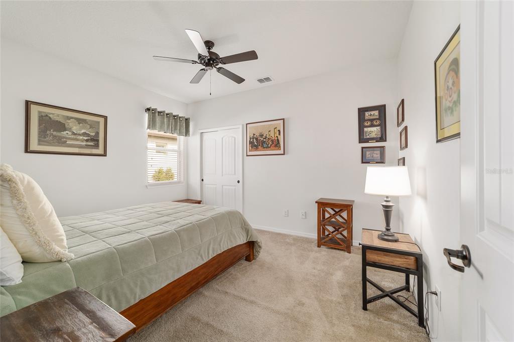 6479 Southwest 94th Circle Ocala, FL 34481 - Photo 44 of 82 a bedroom with a bed and a chandelier