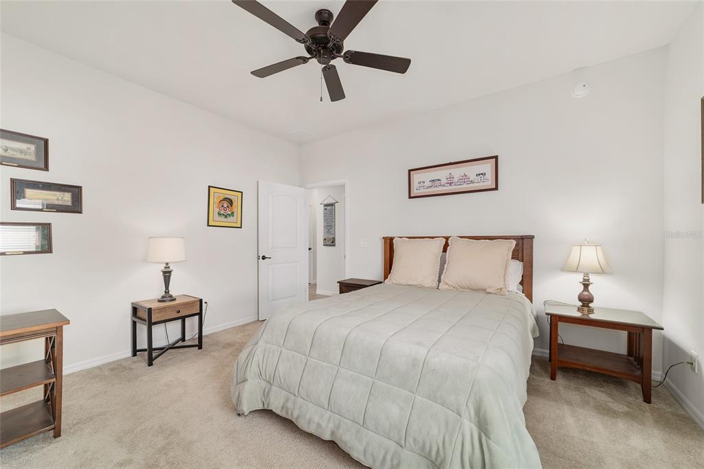 6479 Southwest 94th Circle Ocala, FL 34481 - Photo 45 of 82 a bedroom with a bed and a lamp