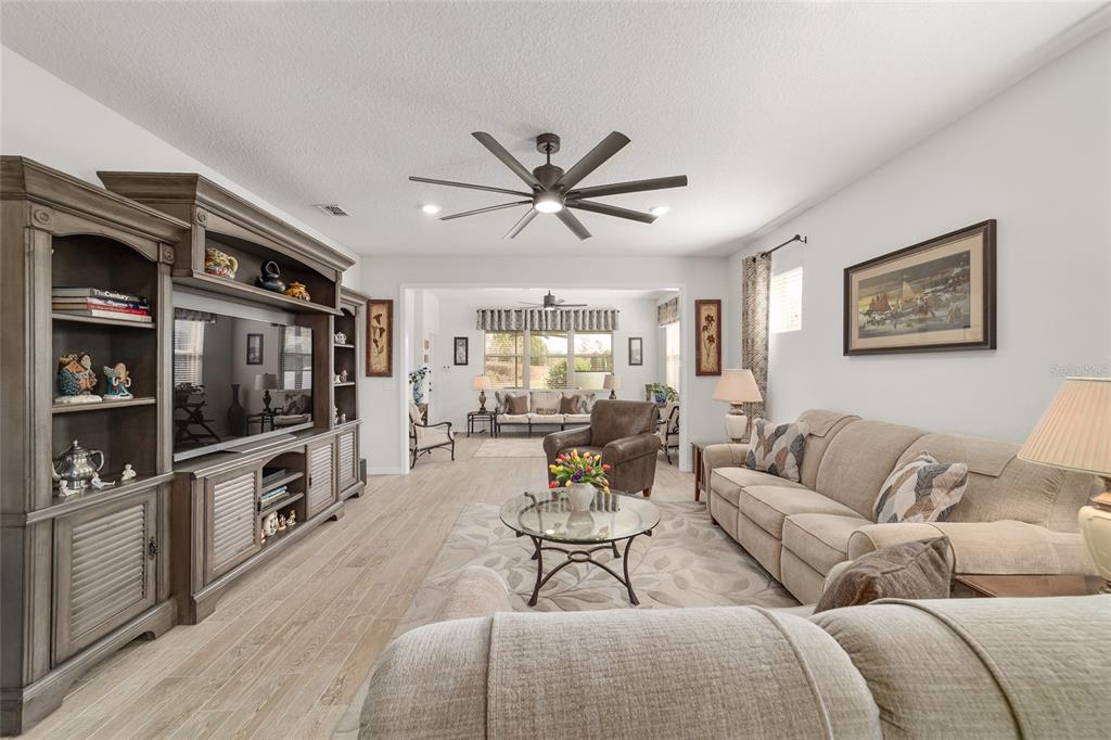 6479 Southwest 94th Circle Ocala, FL 34481 - Photo 9 of 82 a living room with furniture a flat screen tv and a fireplace
