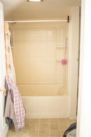 a bathroom with a shower and a sink