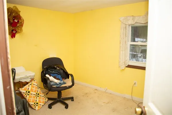 a view of a bedroom with a bed and furniture